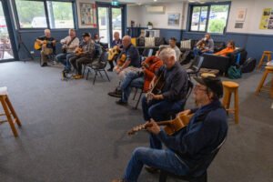 Participants seated with guitars during the Acoustic Guitar Weekend at Saltbush, Balnarring